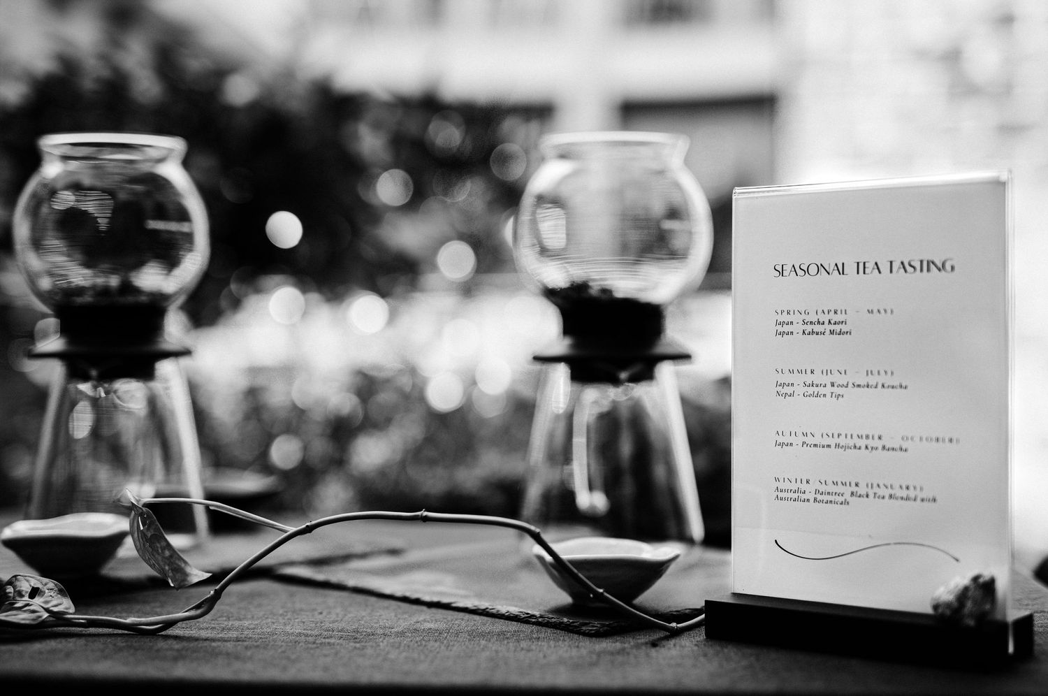 Wedding reception details with place cards and table settings in black and white.