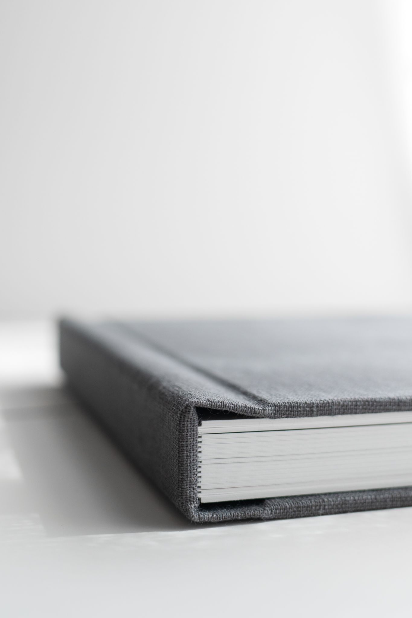 Photo album spread featuring children's portraits in minimalist layout.