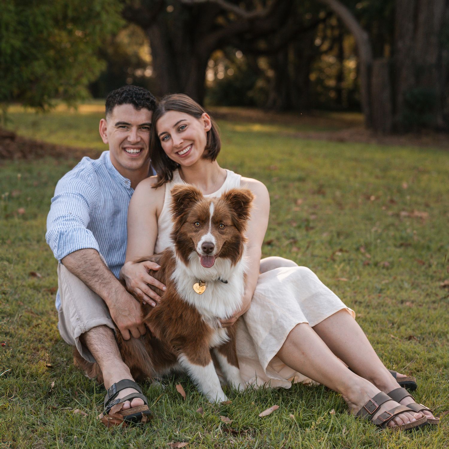 couple-hugging-their-border-collie-during-proposal-photoshoot-in-concord-sydney