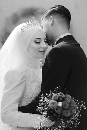 Elegant black and white wedding portrait with roses and baby's breath bouquet.