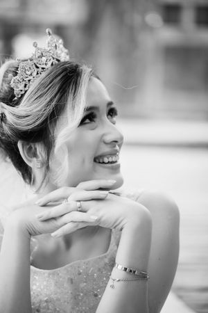 Black and white portrait of bride wearing tiara and strapless gown.