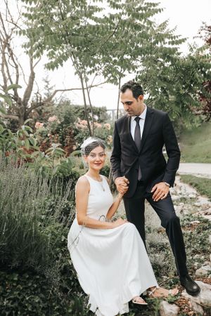 A romantic garden wedding scene with a couple in formal attire.