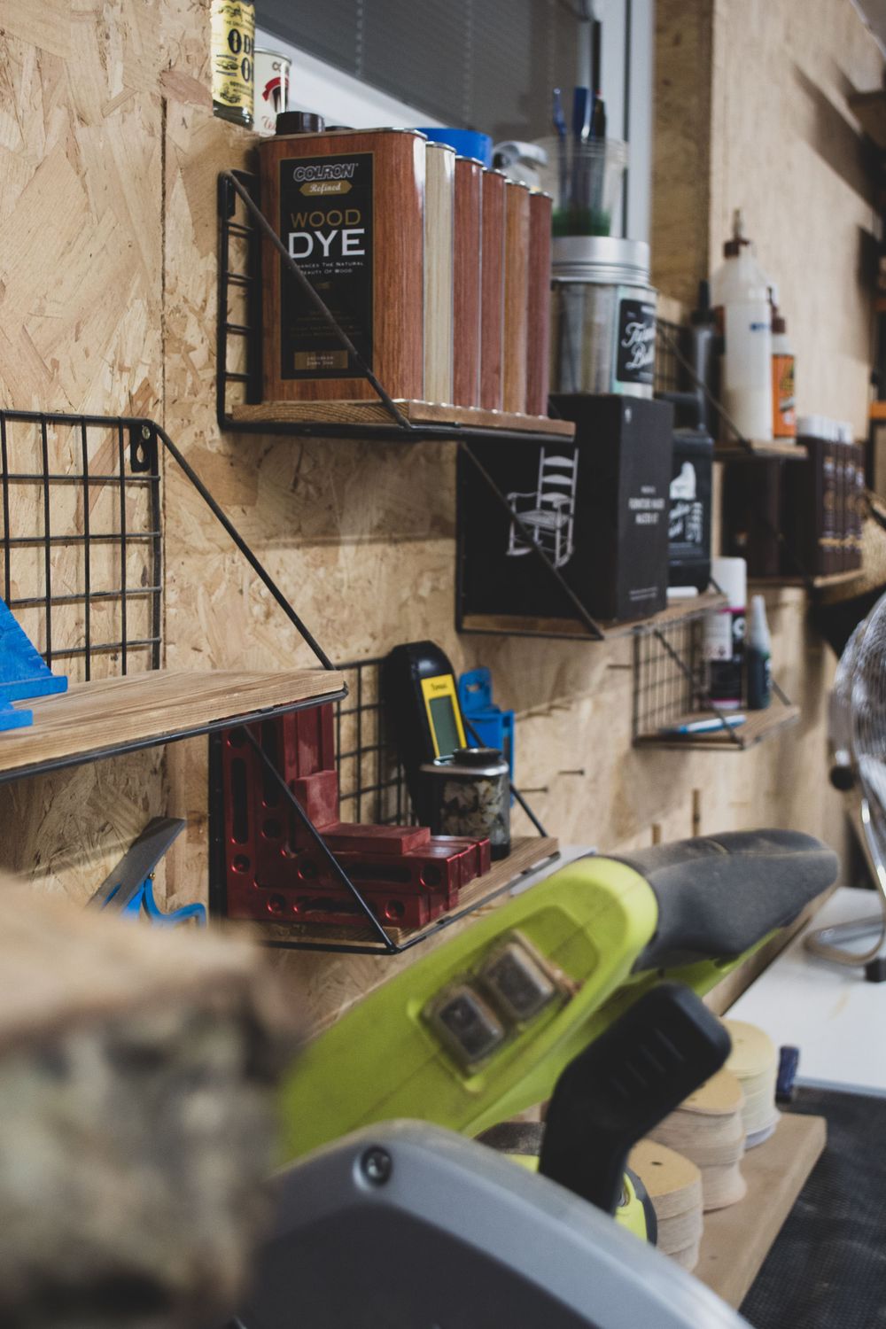 Close-up shots of workshop storage shelves with various tools and supplies mounted on a textured wall.