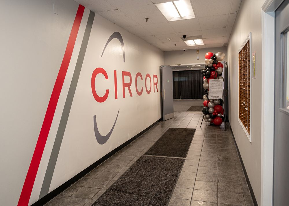 White hallway with red CIRCOR logo and trim along corridor wall.