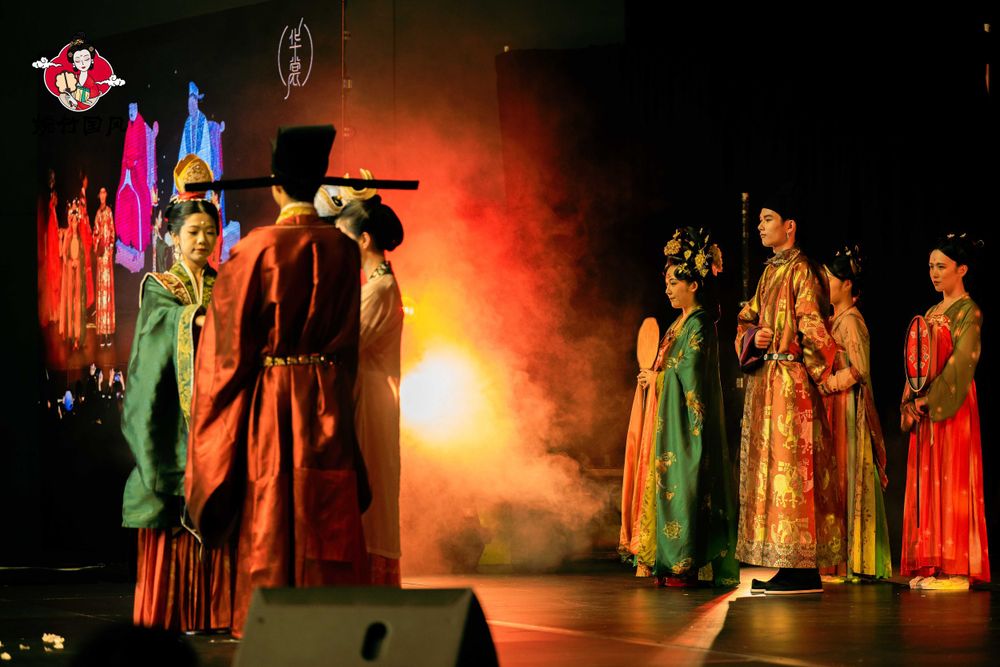 Dramatic stage photography of a traditional Hanfu fashion show featuring elegant performers, by an Auckland event photographer.