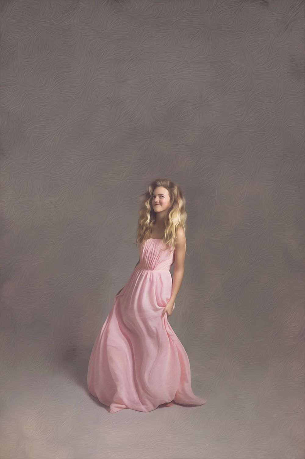 Dancer in flowing pink gown poses gracefully against grey background.