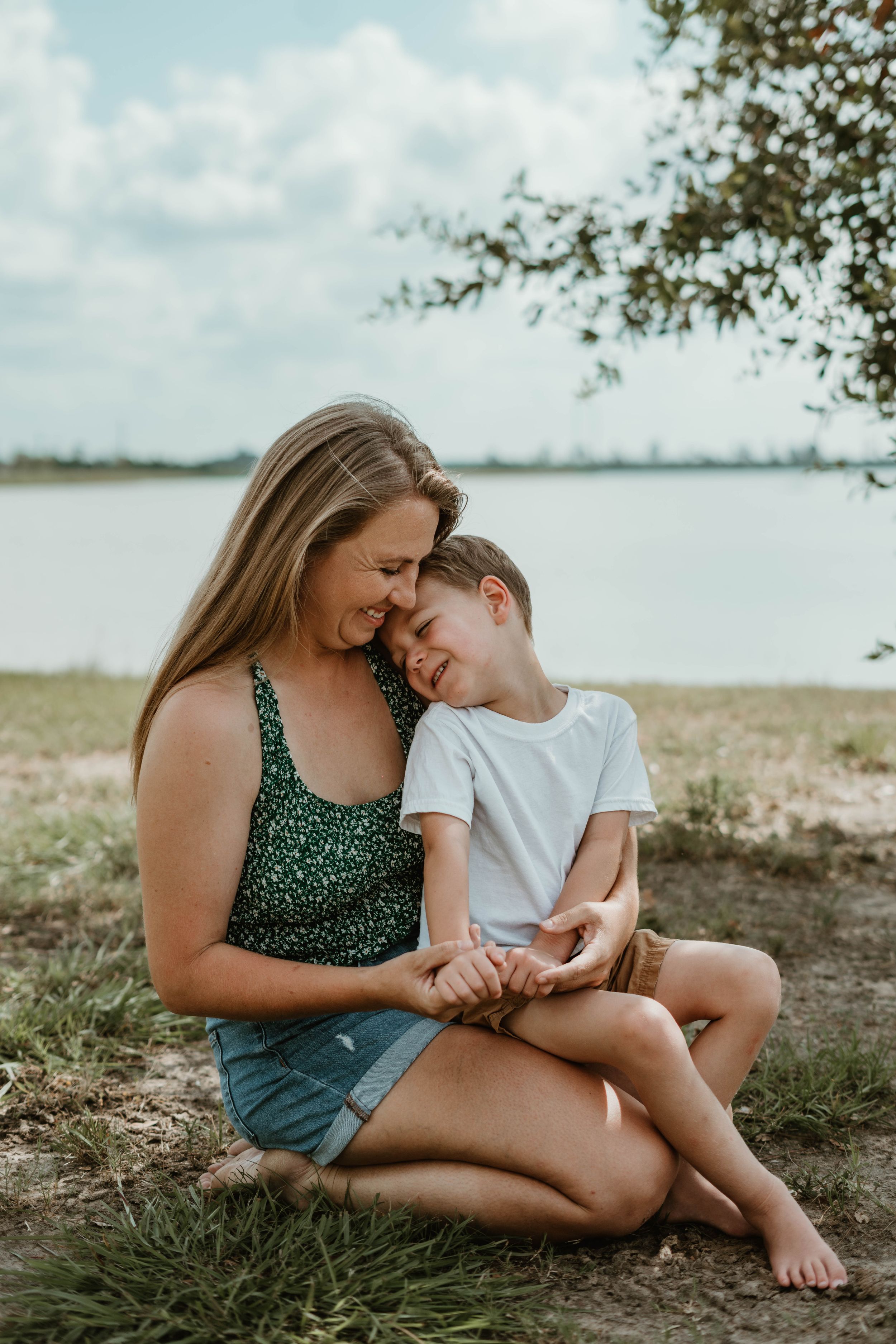 Heartwarming outdoor portrait by lakeside with natural lighting and gentle expressions.
