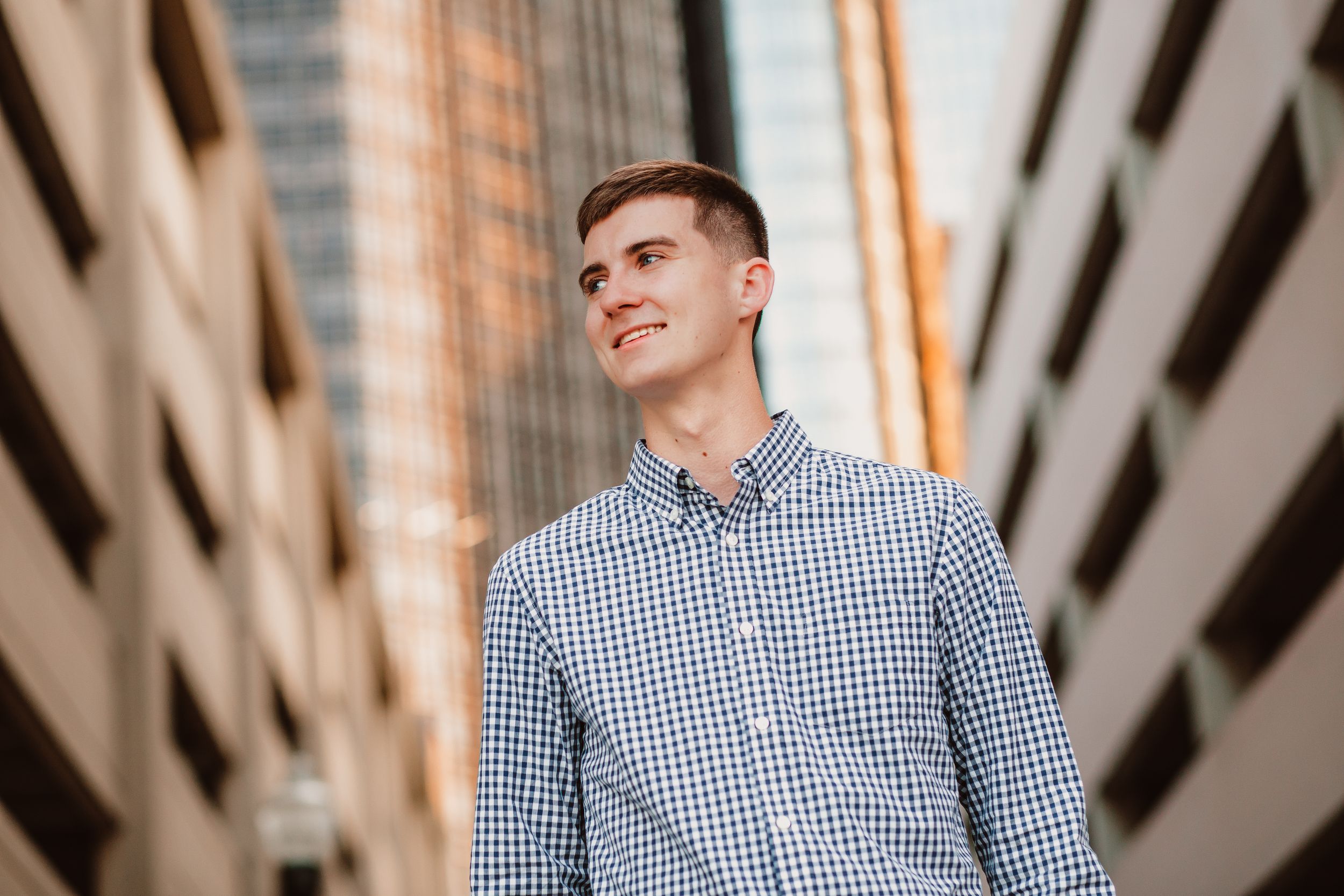 Urban portrait against modern architecture with diagonal lines and natural lighting.