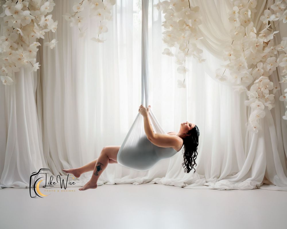 Ethereal white wedding dresses displayed in a dreamy boutique setting with soft lighting and flowing fabric.