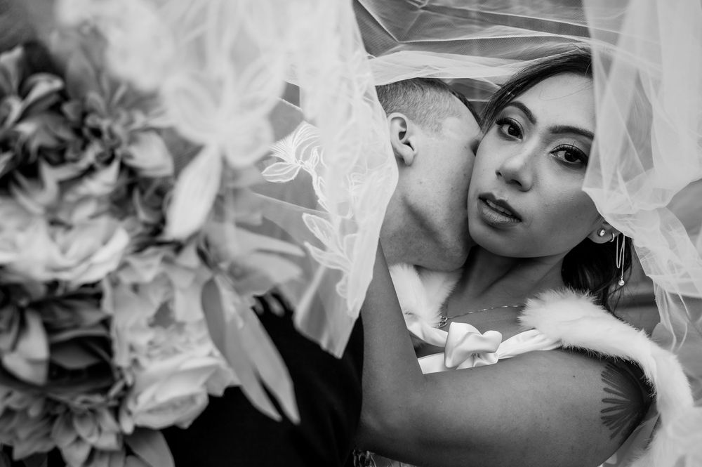 Romantic black and white wedding detail shots with delicate veil and floral elements.