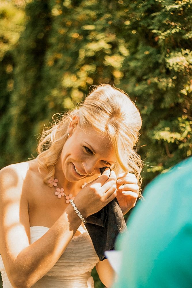 Emotional candid moment captured during outdoor wedding celebration.