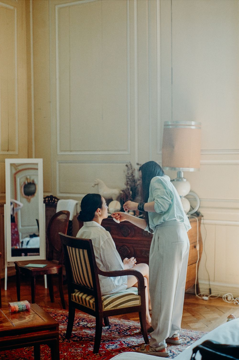 Elegant room with classic molding and vintage furniture during wedding preparation.