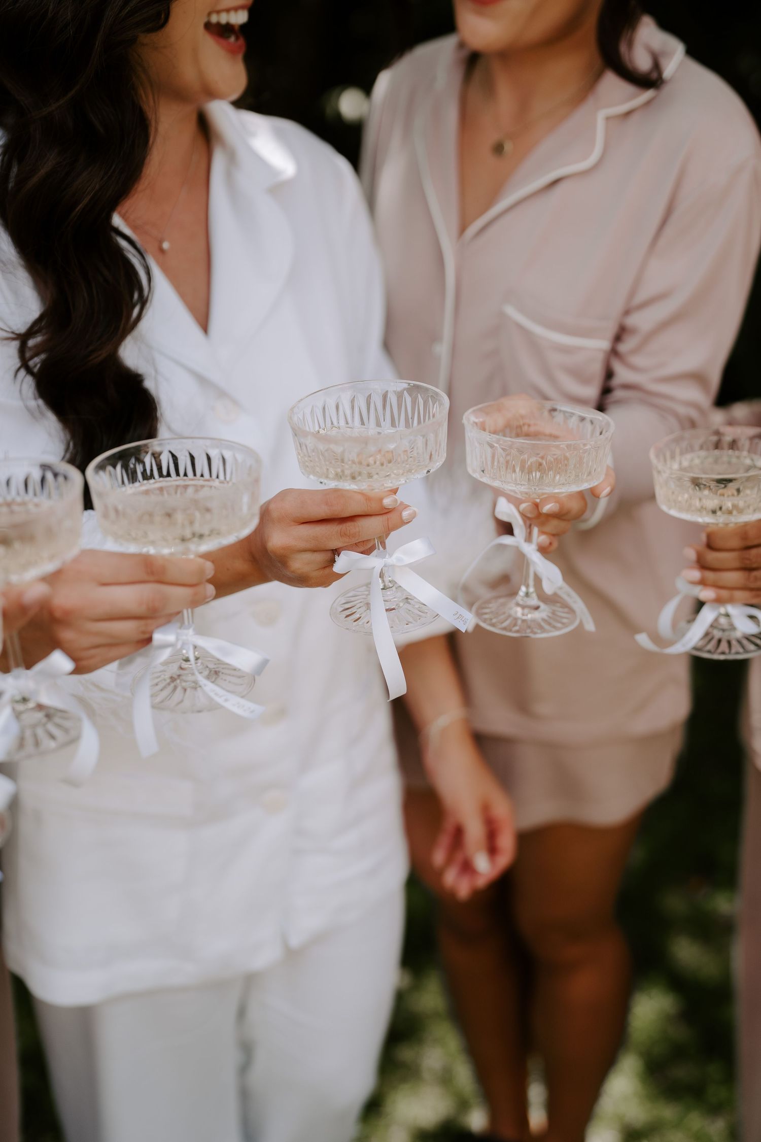 bride and bridesmaids cheering  with champagne glasses