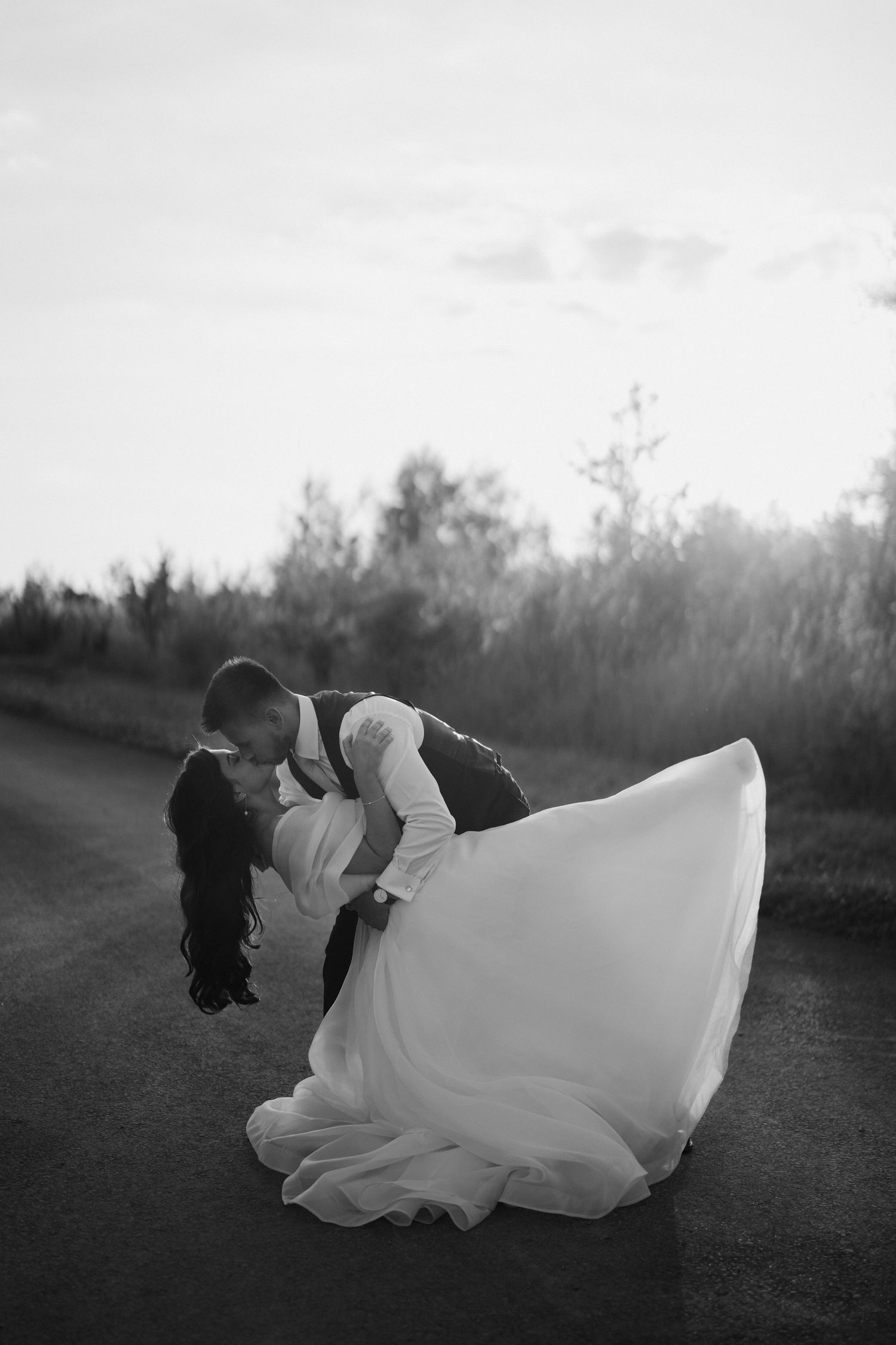 bride and groom kissing during sunset at yardspace old gore Cirencester