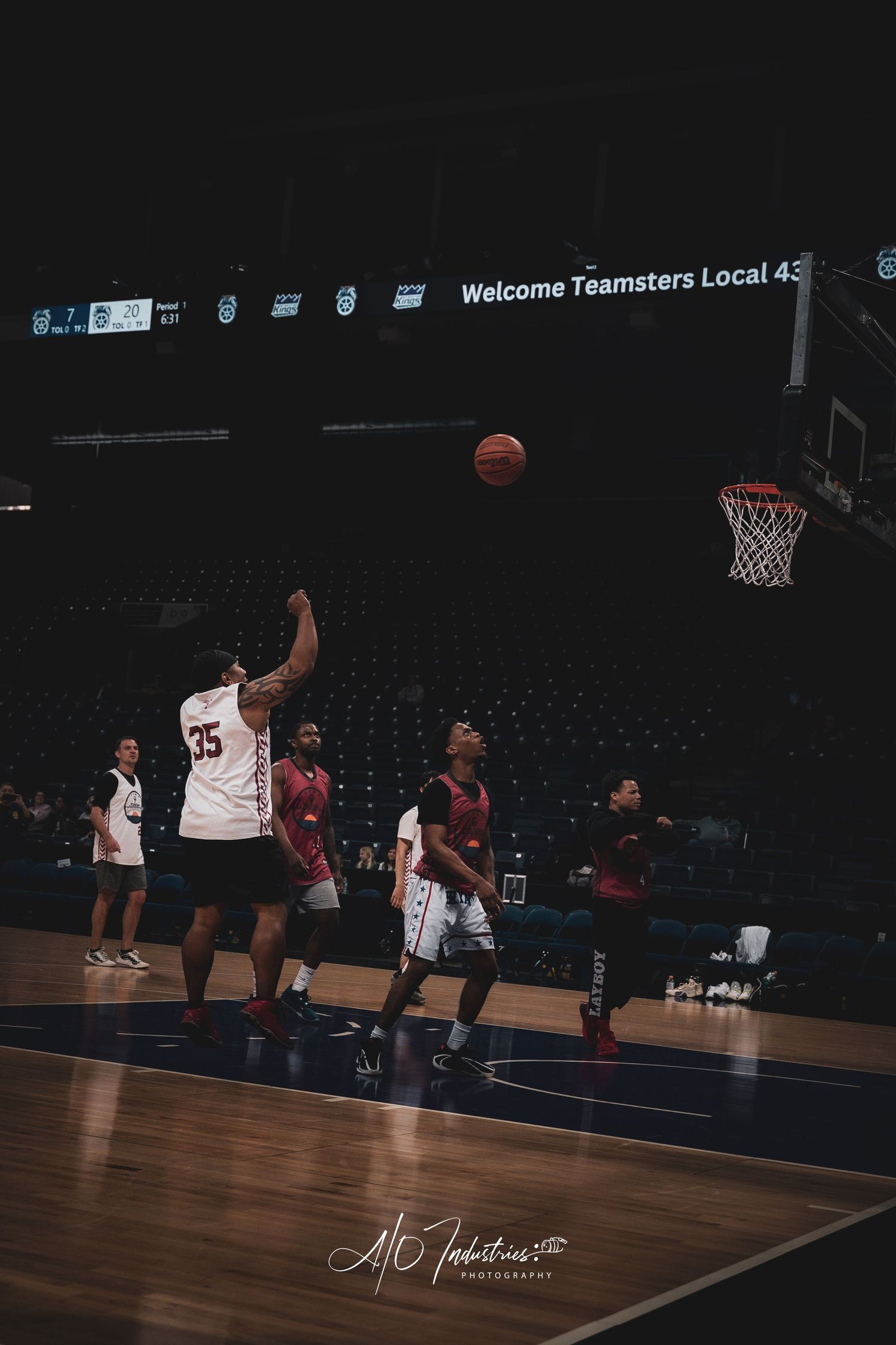 Player wearing jersey number 35 shoots basketball toward hoop during indoor arena game with teammates watching.