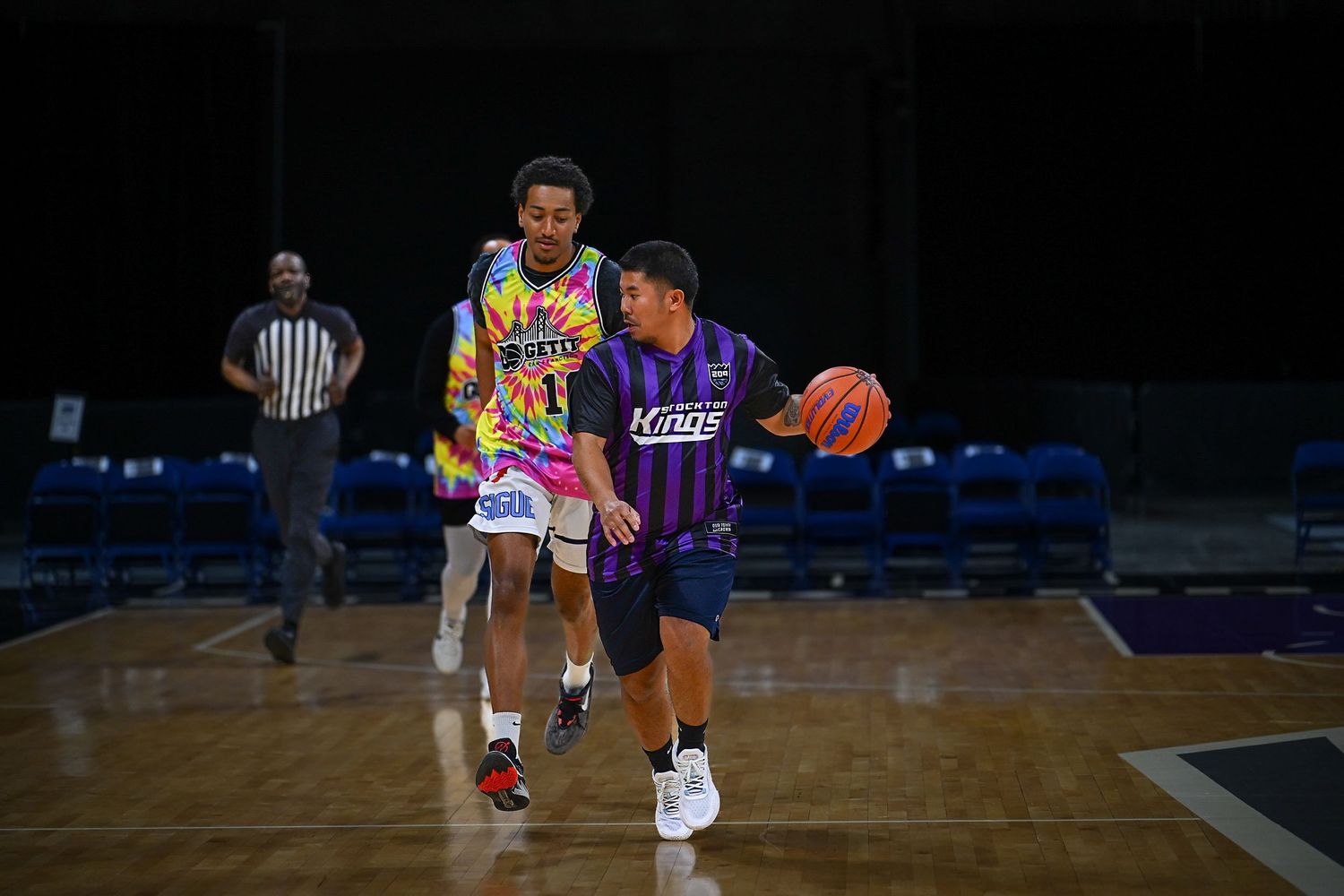 Youth basketball players practicing offensive moves during a training session.