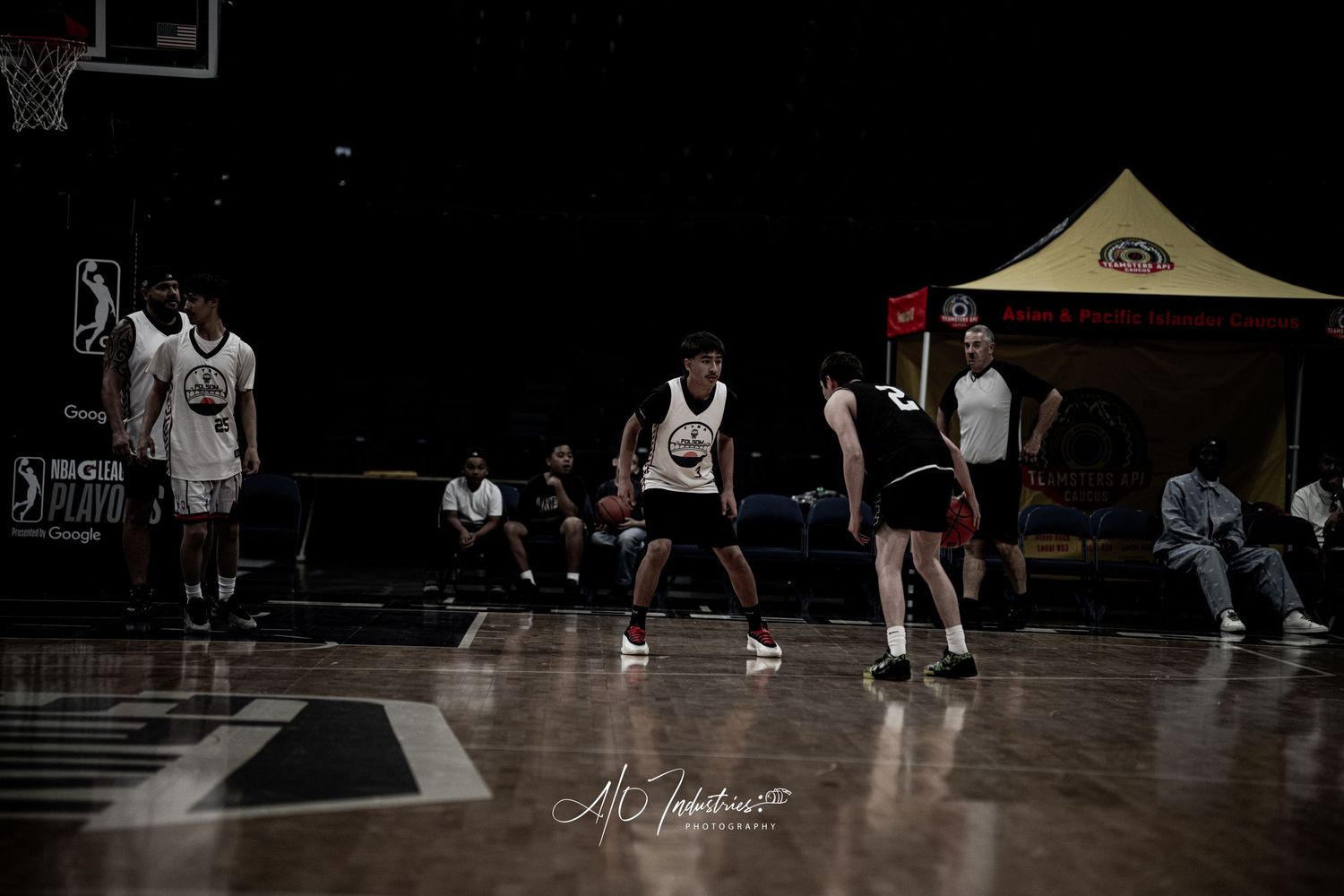 Basketball players compete in an indoor court during a BIG3 league game with spectators watching in the background.