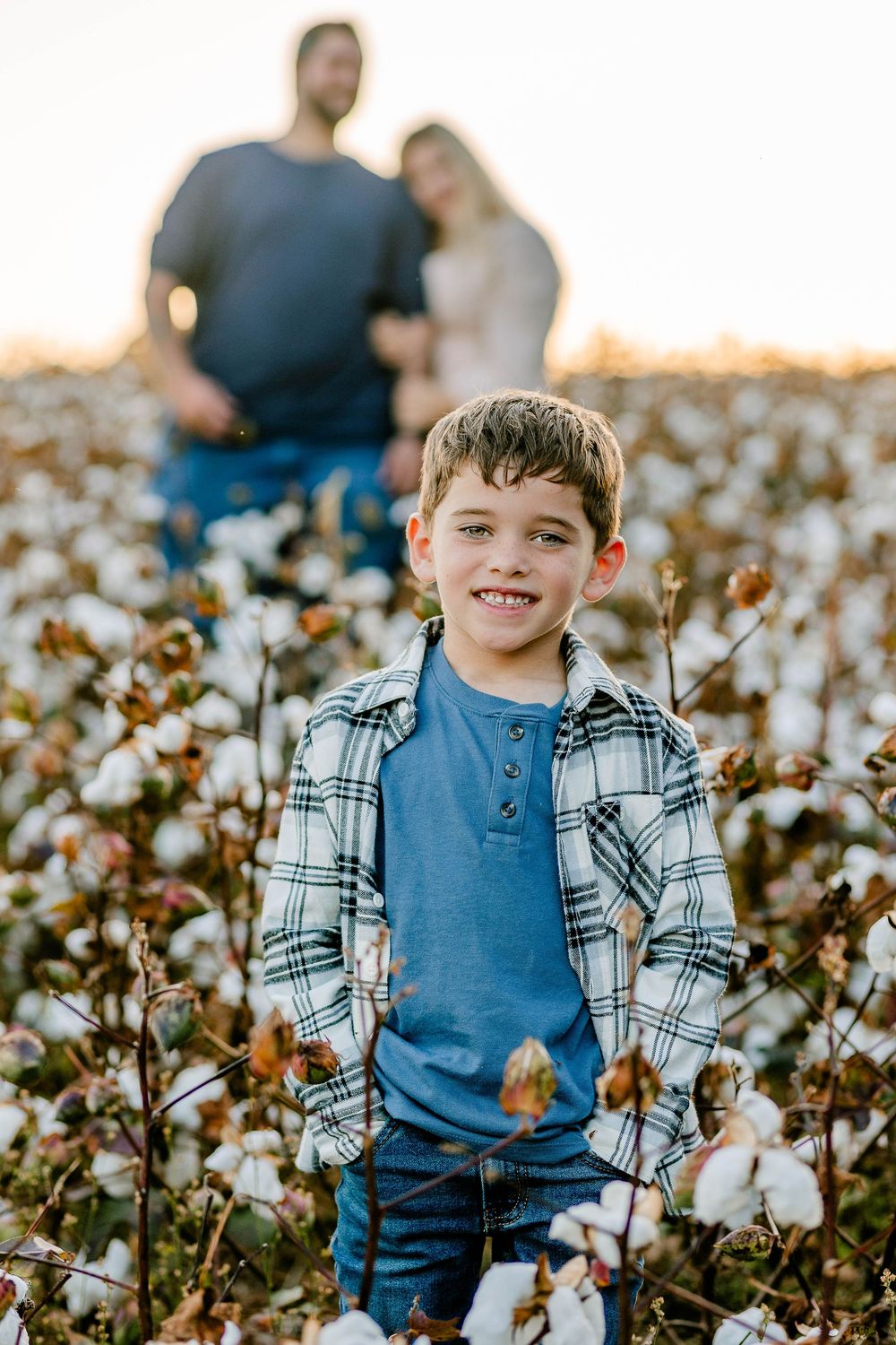 Warm family portraits in a cotton field near Clover, SC—snuggles, giggles, and endless cotton rows at golden hour.