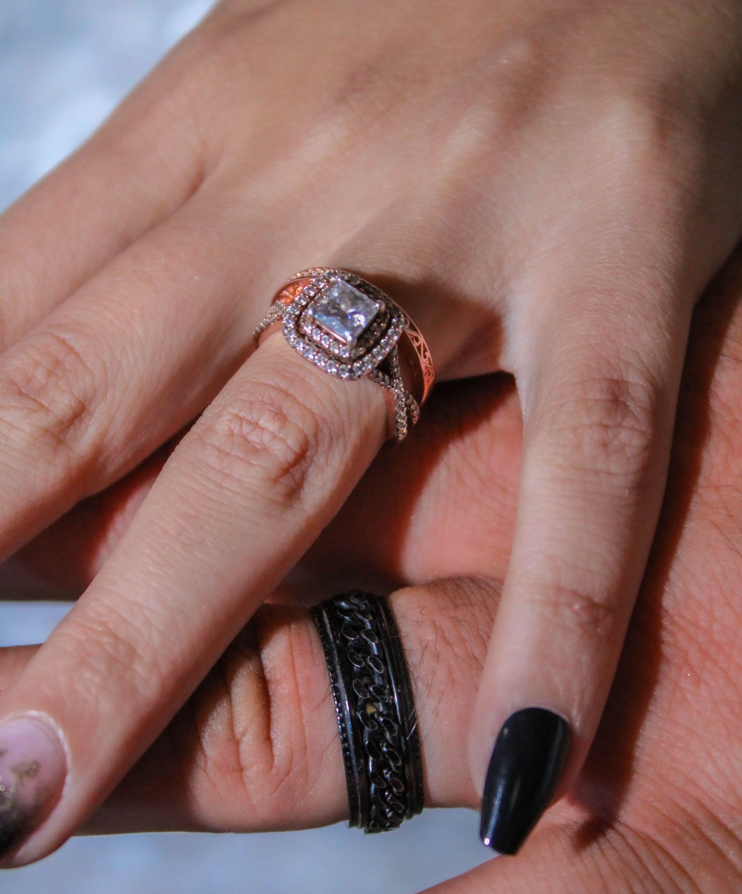 Close-up shots of hands wearing engagement rings and wedding bands.
