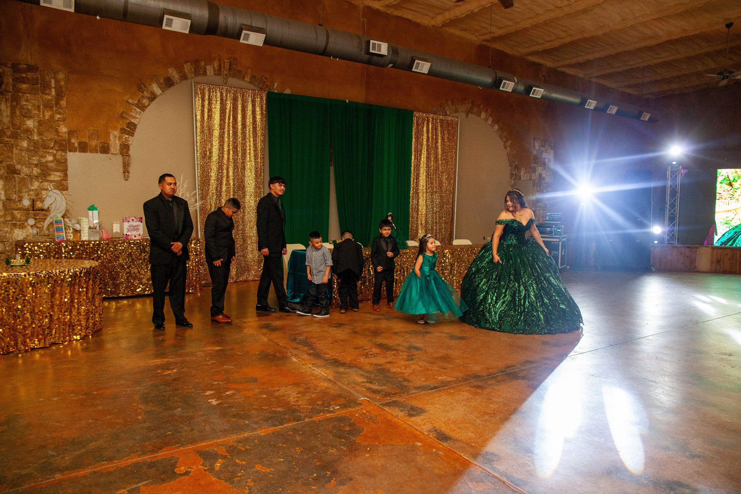 A spacious event venue with stone walls and dramatic lighting.