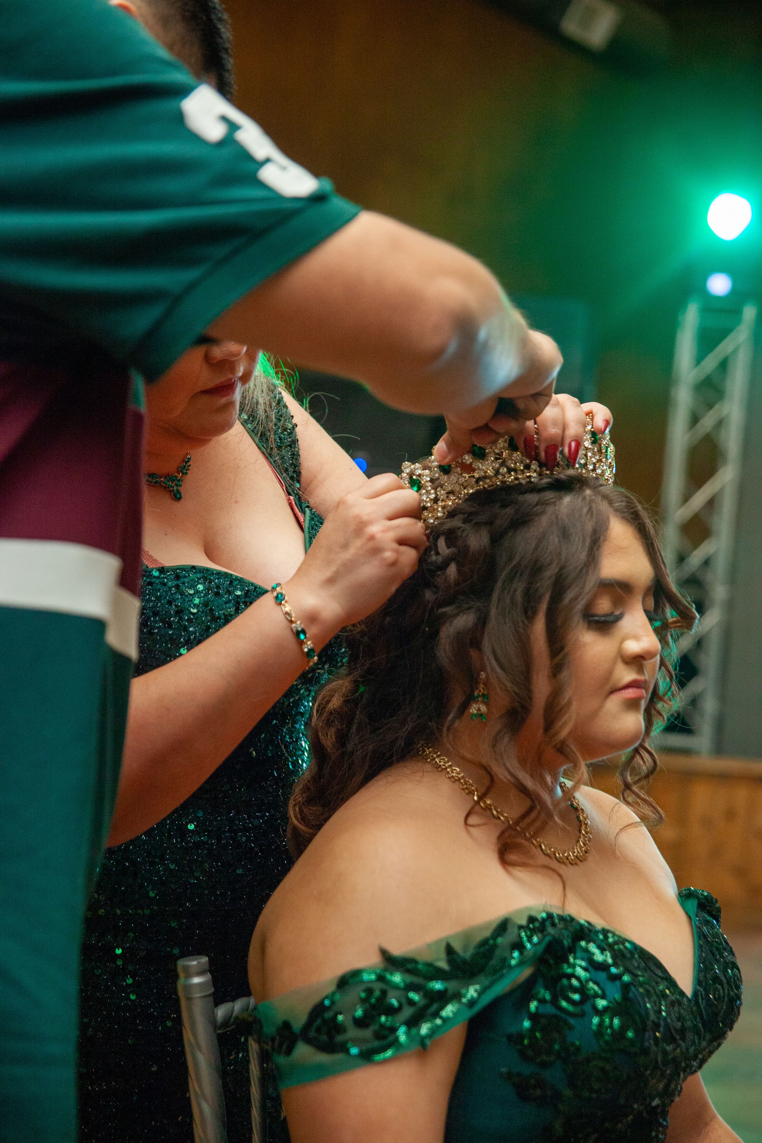 Someone getting their hair styled with emerald green lighting in the background.