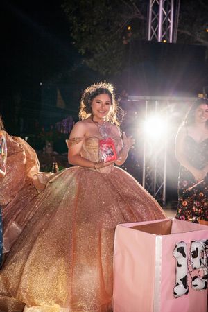 A sparkly gold ballgown dress being worn at an evening event.