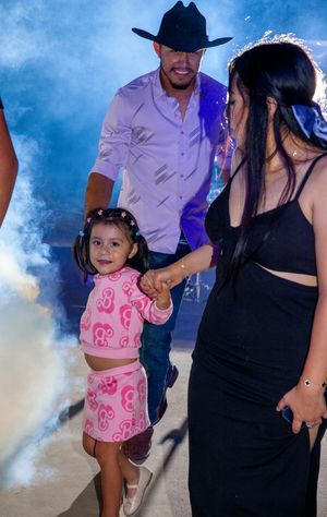 Family celebration with smoke effects and a young child in pink outfit.