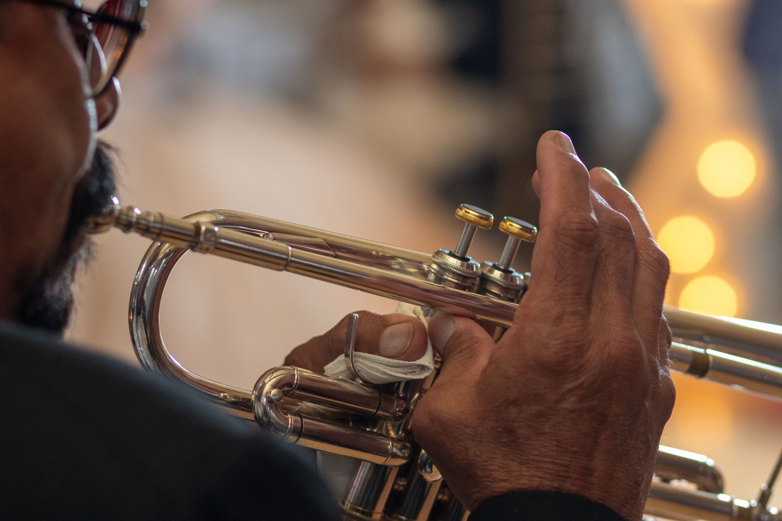 Musicians playing brass instruments during a performance.