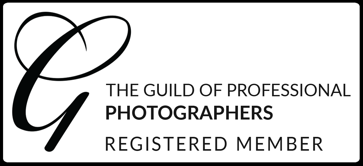 Professional black and white logo for The Guild of Professional Photographers showing registered member status.