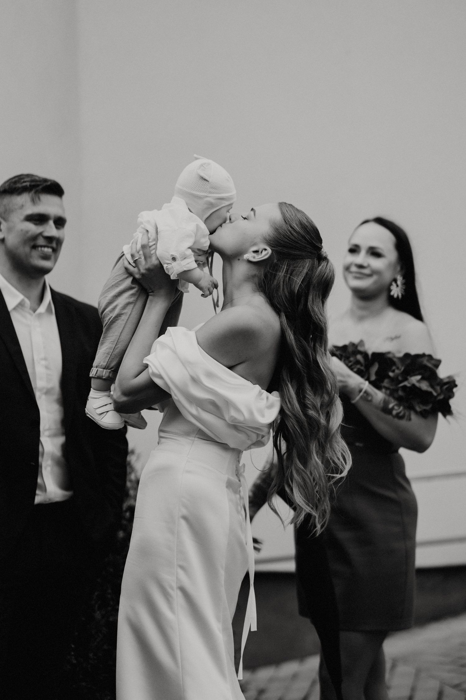 Wedding party enjoying drinks and celebrations in black and white photography.
