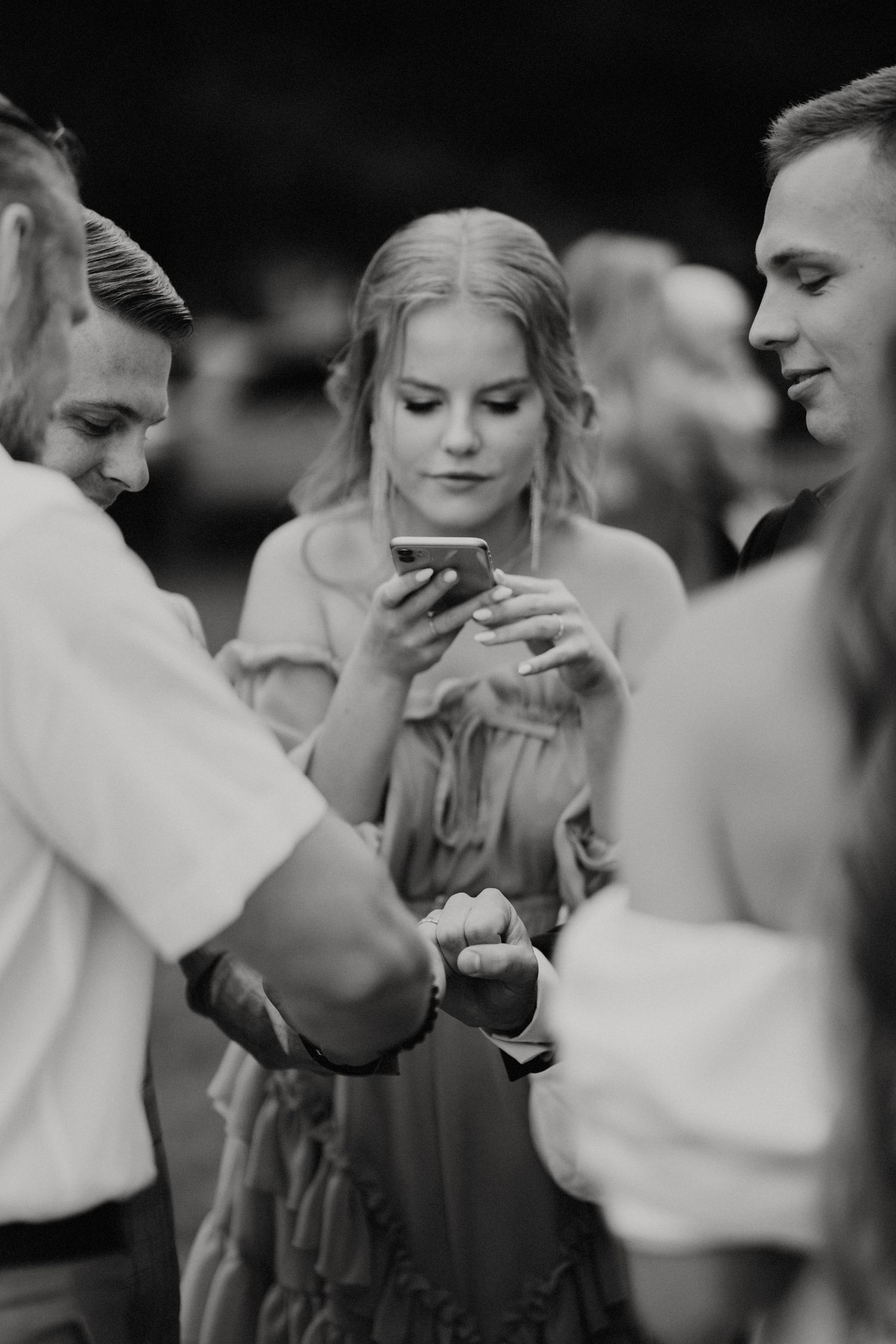 Wedding guests sharing drinks and conversations during outdoor reception.