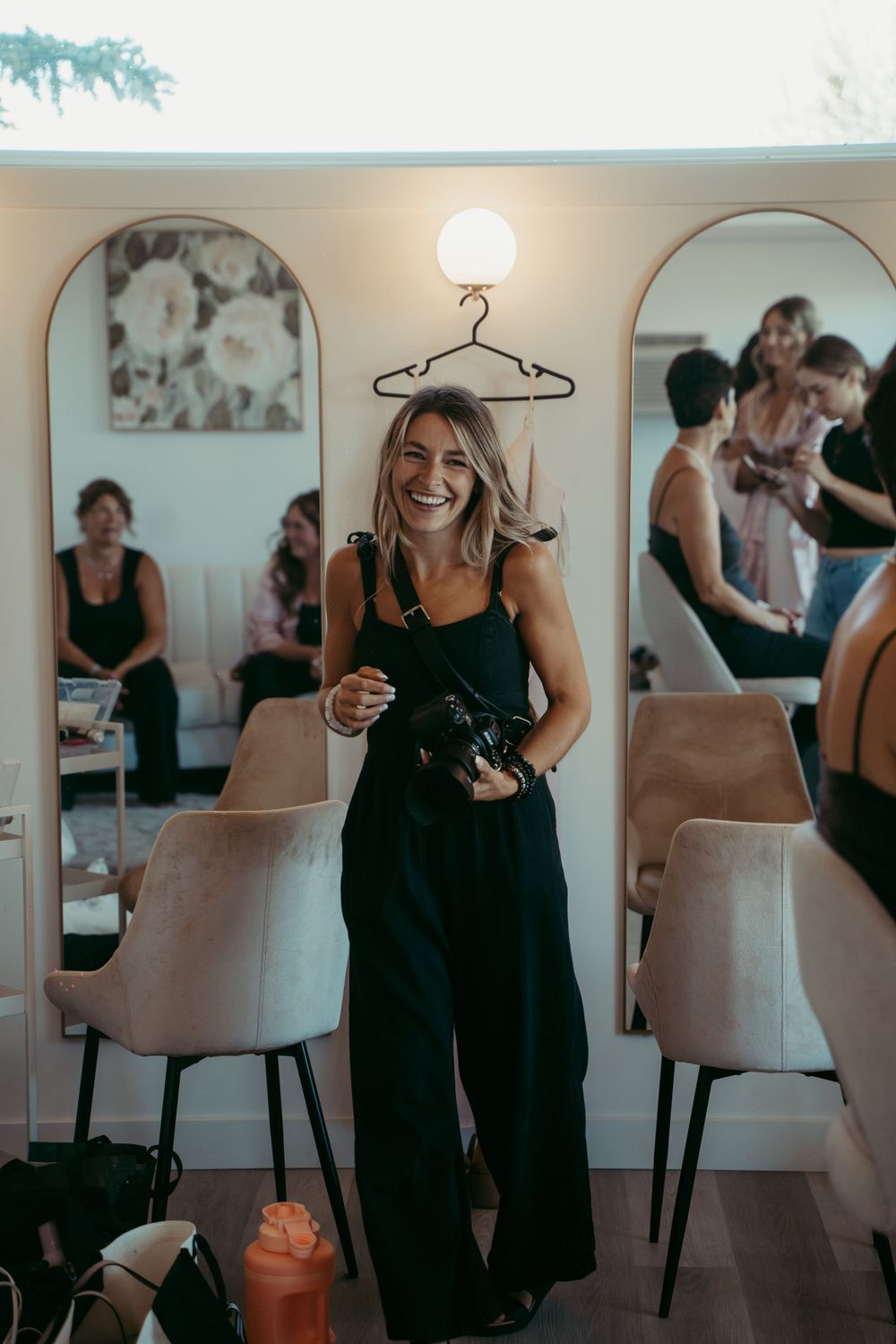 Candid shot at an indoor gathering showing laughter and joy in a room with contemporary decor and soft lighting.