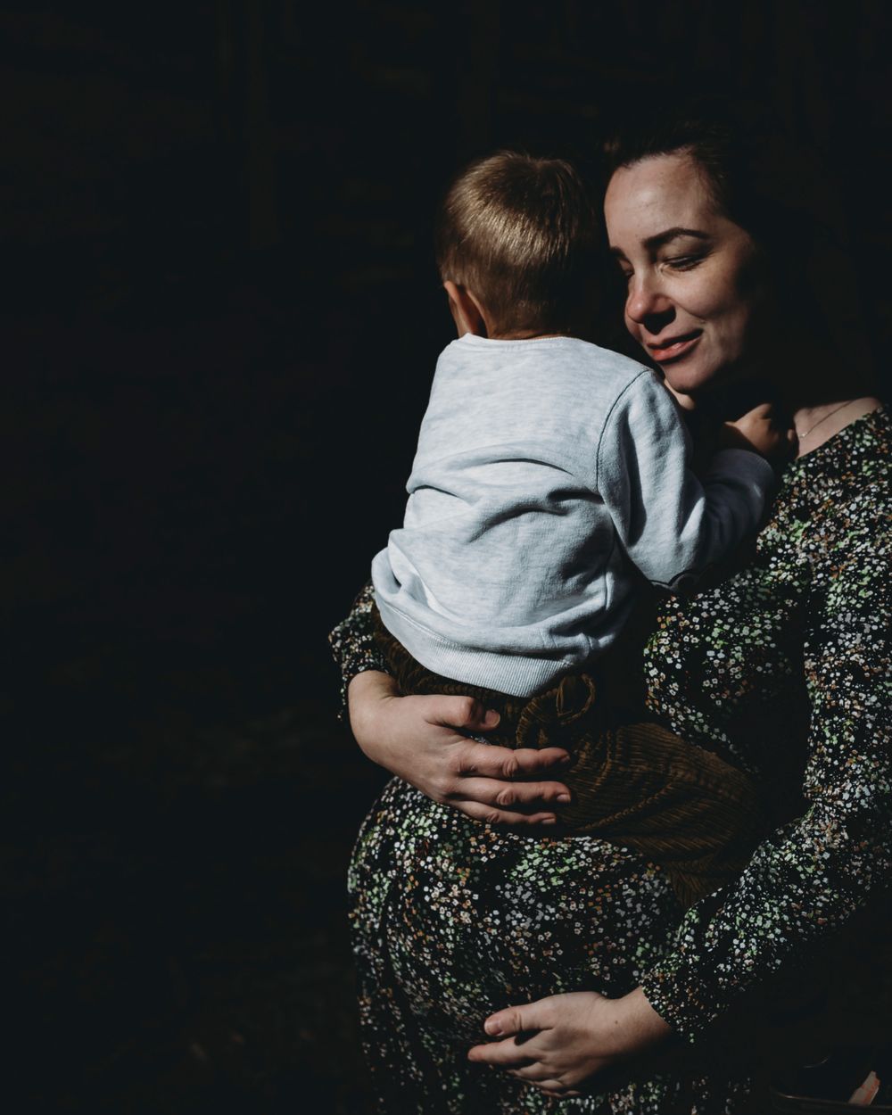 mãe e filho durante momento de afeto, foto colorida  e branco na natureza em sessão fotográfica de família em Alcobaça Portugal