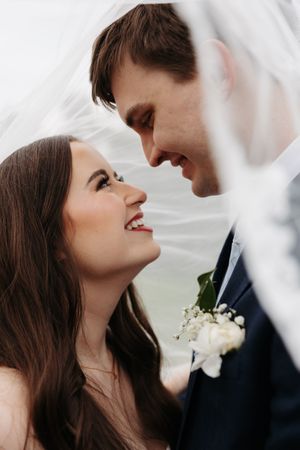 A romantic wedding couple shares intimate close-up moments in a series of five connected photos.
