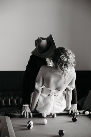 Black and white artistic sequence showing someone leaning over a billiards table during a game.