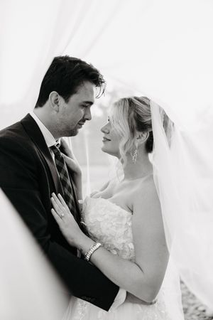 Black and white wedding portrait series showing tender moments between newlyweds.