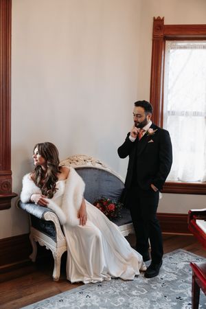 A wedding first look sequence showing a couple's emotional reaction upon seeing each other in a vintage room.
