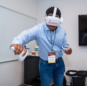 Participant testing virtual reality headset during interactive technology demonstration.