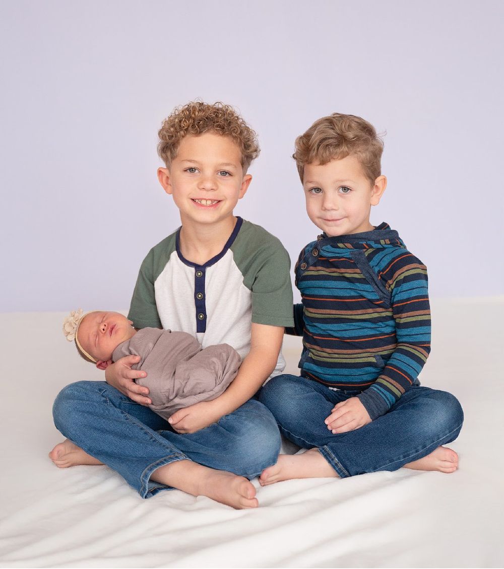 Newborn girl with family in natural light studio by Bartlesville Newborn Photographer Kristi Bray Photography