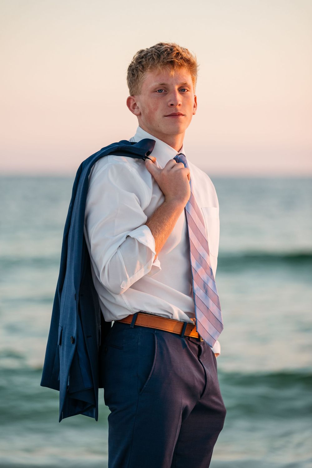 Fort Walton Beach Senior portraits lifestyle shoot at the boardwalk during sunset. Surfing photoshoot at the Boardwalk on Okaloosa Island FL