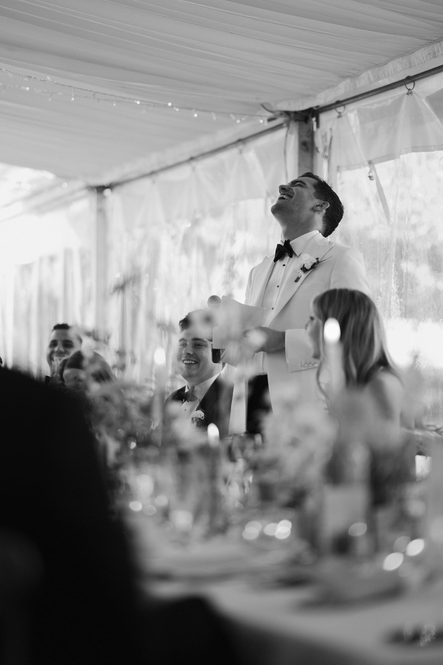 groom giving speech surrounded by guests laughing at hamswell house in bath