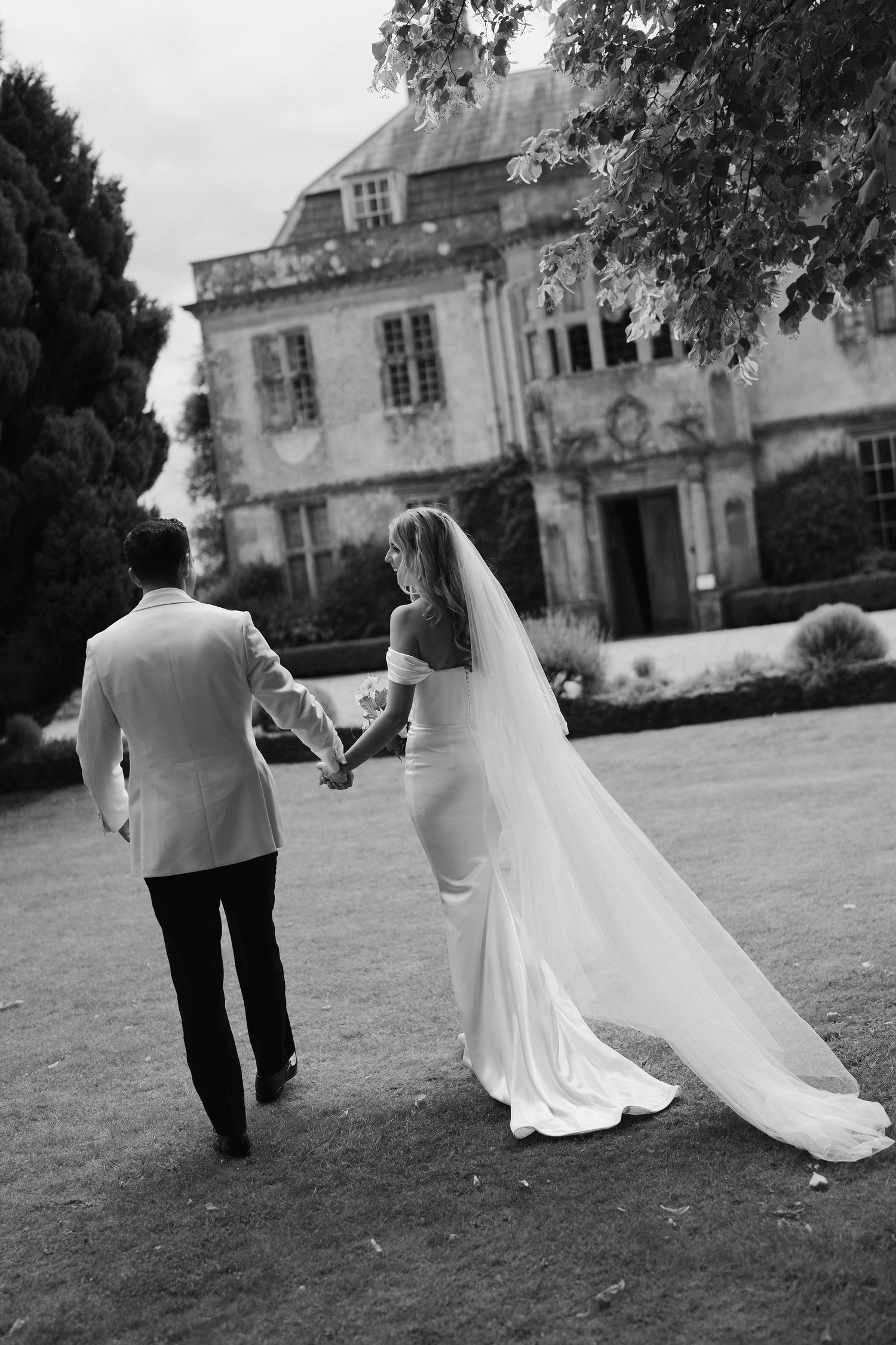 bride and groom walking away from ceremony  at Hamswell house in bath