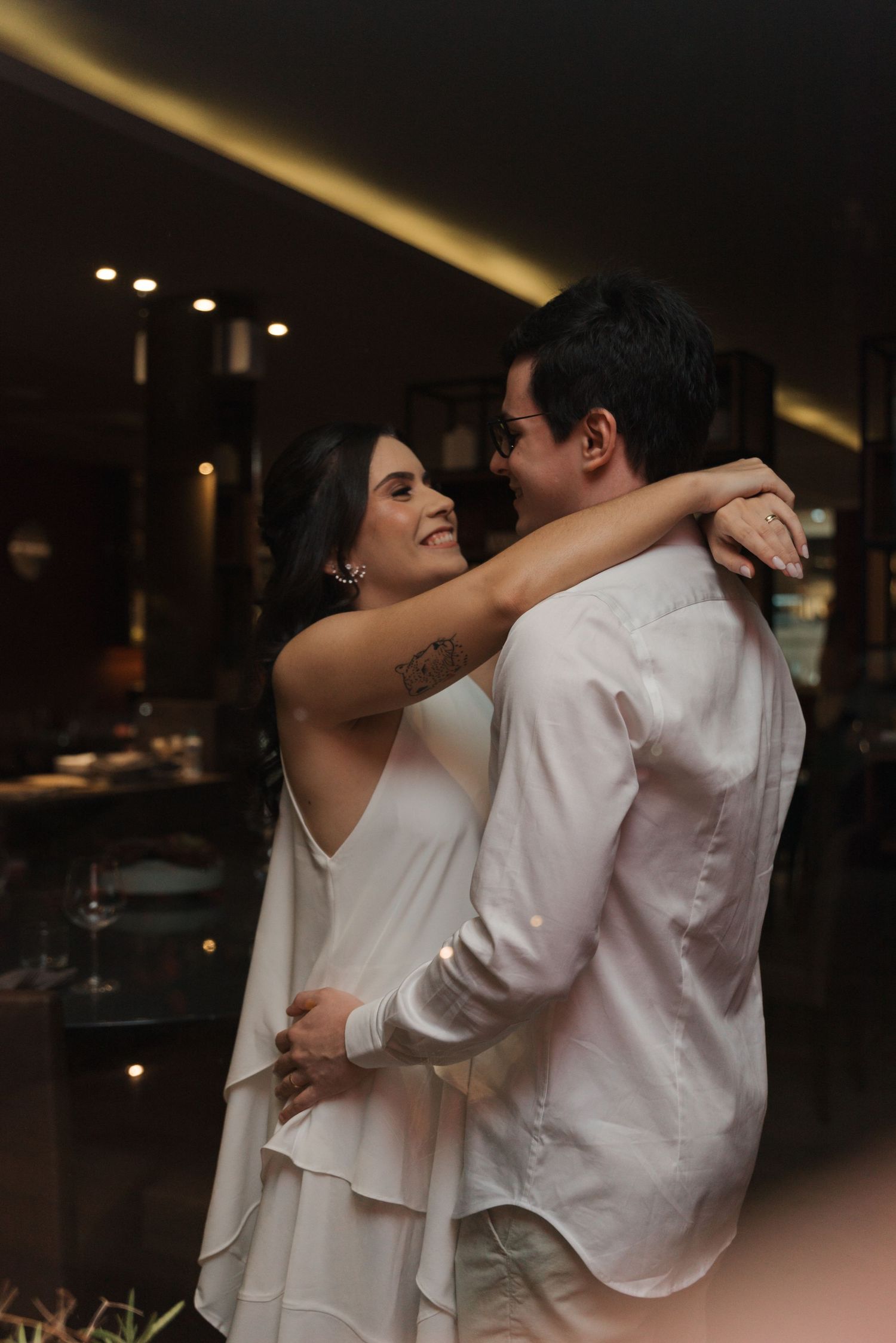 A romantic dance moment captured in dim lighting with warm ambient glow.