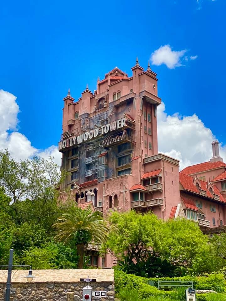 Imposing Hollywood Tower Hotel building with terracotta facade against blue sky.