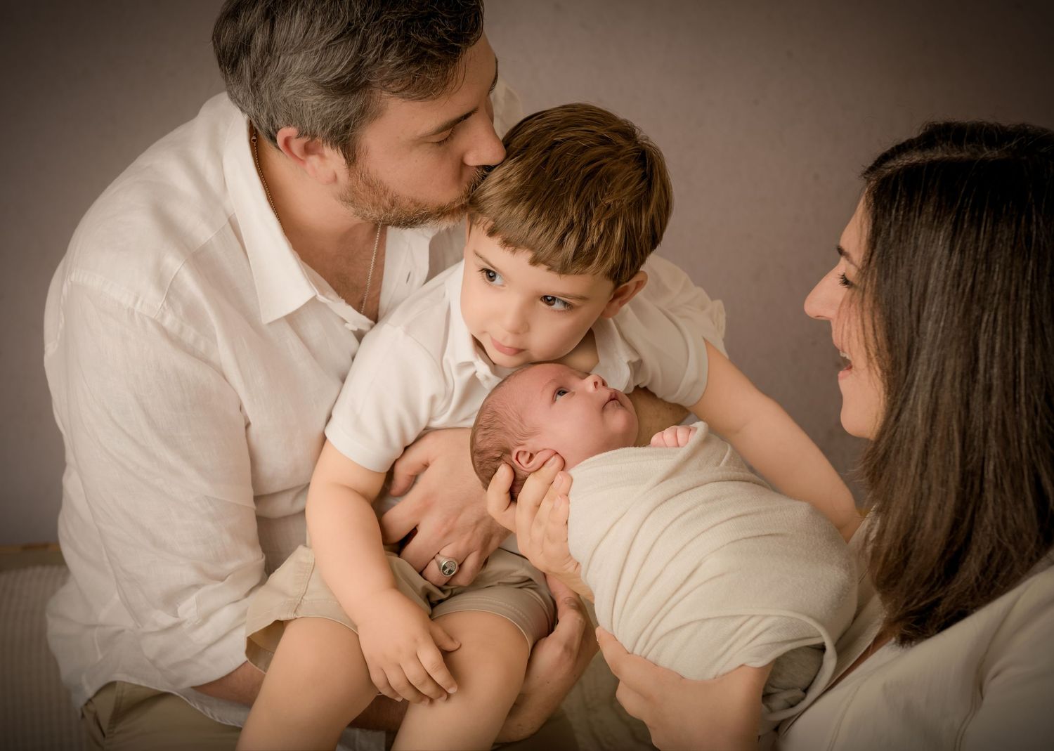 A series of intimate black and white family photos showing tender moments of affection and connection.