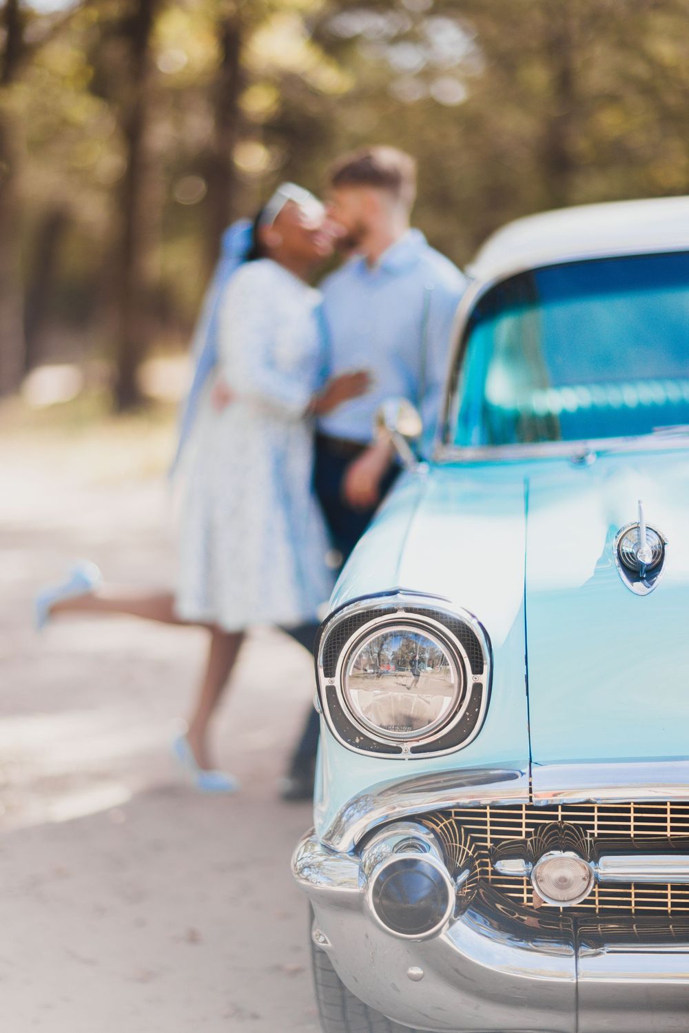 Vintage light blue classic car details shown in a series of close-up shots focusing on chrome trim and headlights.