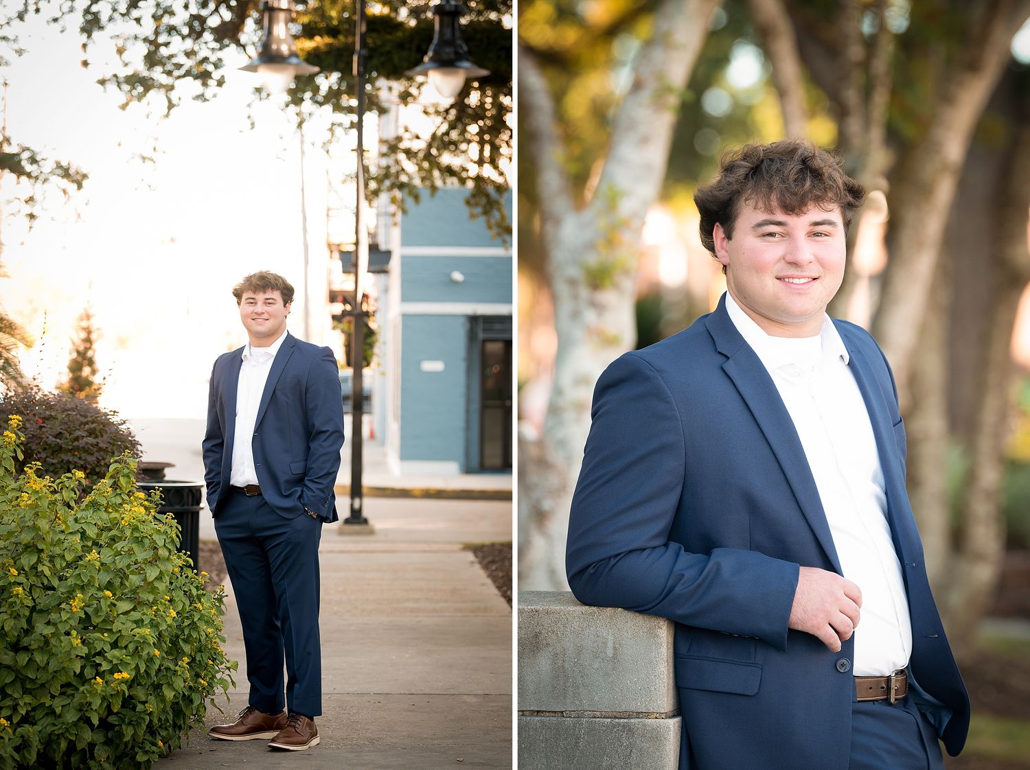 Young man in navy blazer and white shirt poses outdoors for senior portraits in a park setting.