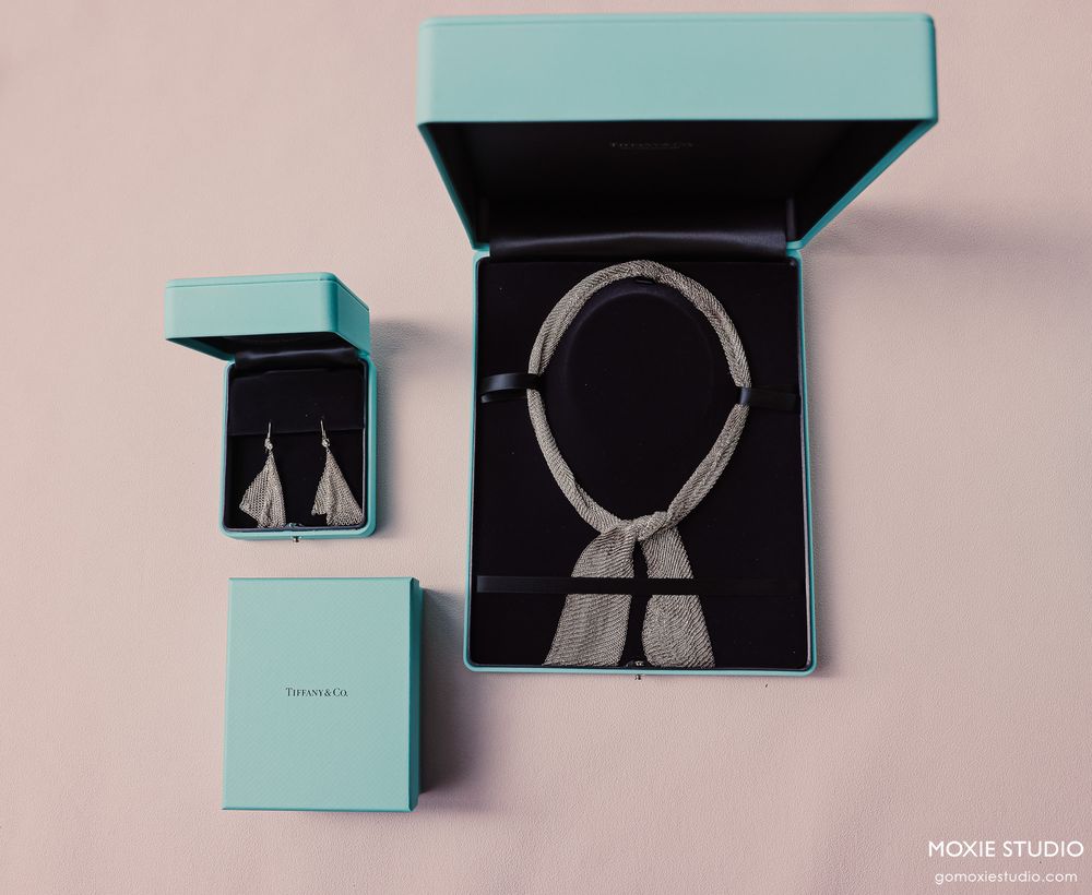 Elegant Tiffany & Co. diamond necklace in black jewelry box with matching earrings in teal gift boxes.
