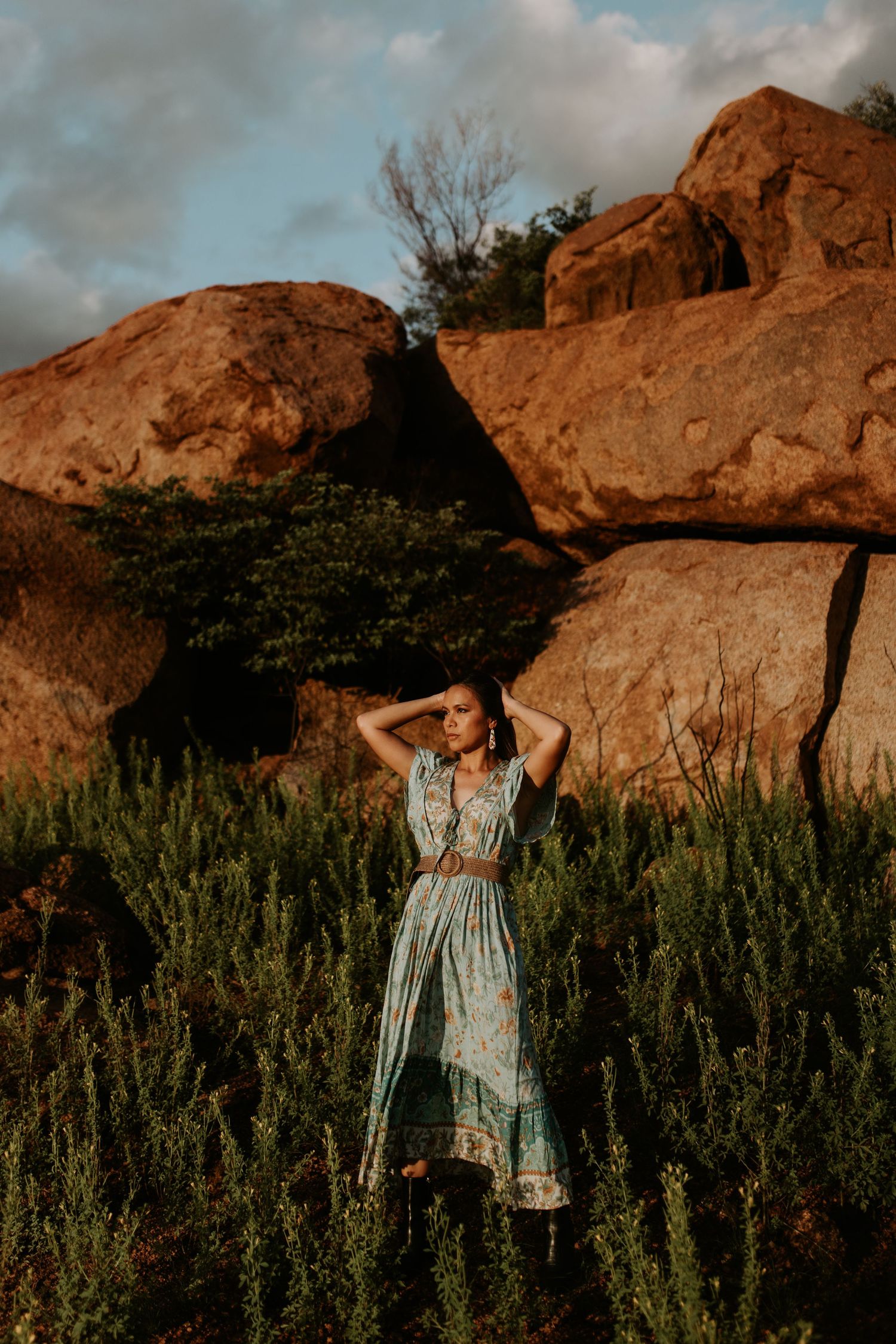 Christina standing in front of the red rocks at the Granite Mines in Mount Isa