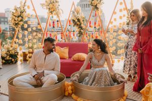 Wedding celebration setup with golden floral decorations and orange accents.